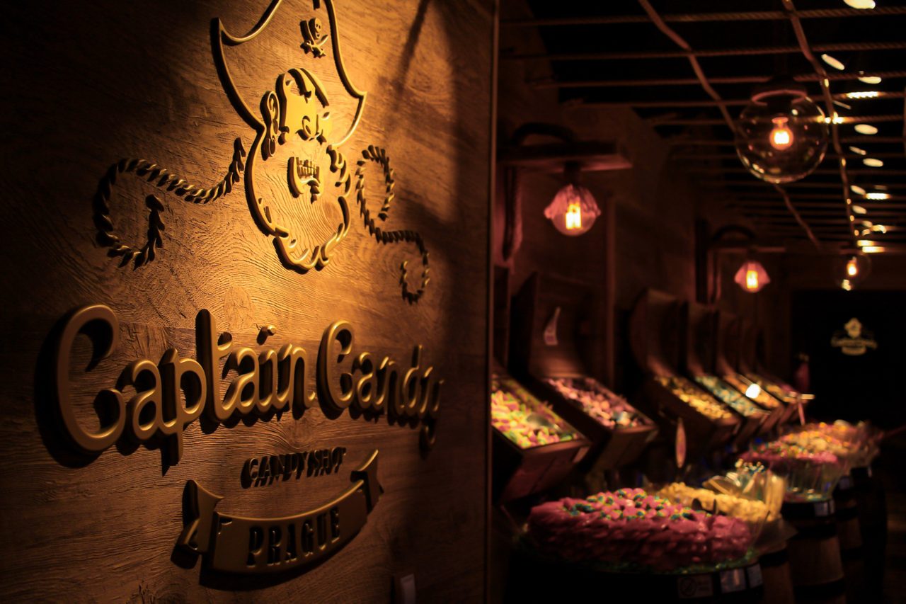 A warm-lit candy shop on a winter evening in Prague