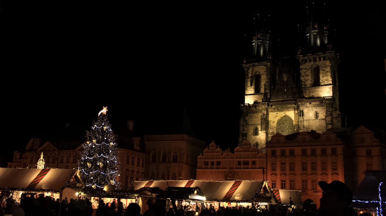The Old Town Square Christmas market beneath the Gothic spires of the Tyn Church