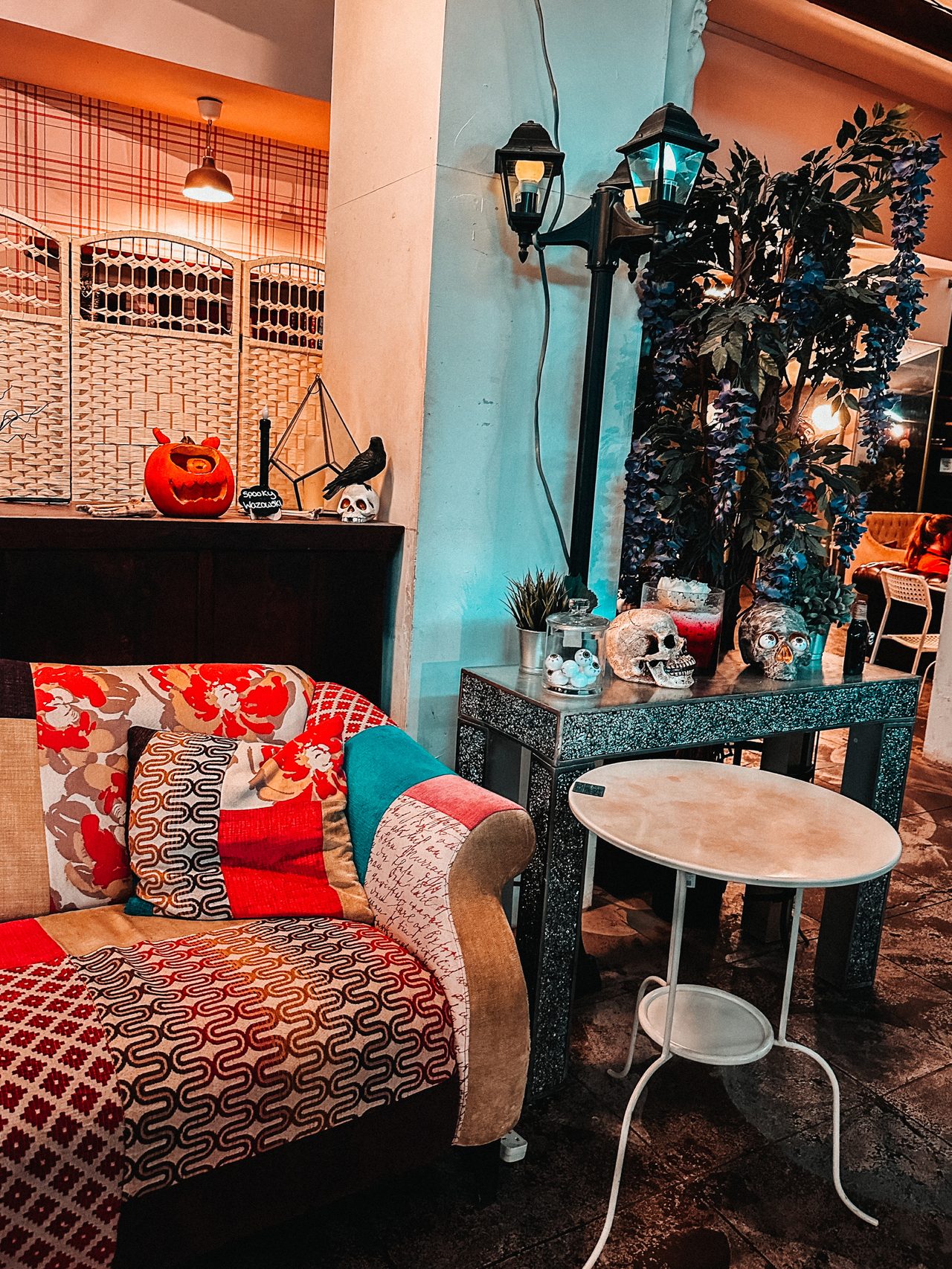 An eclectic cafe corner in teal and red with quirky decor