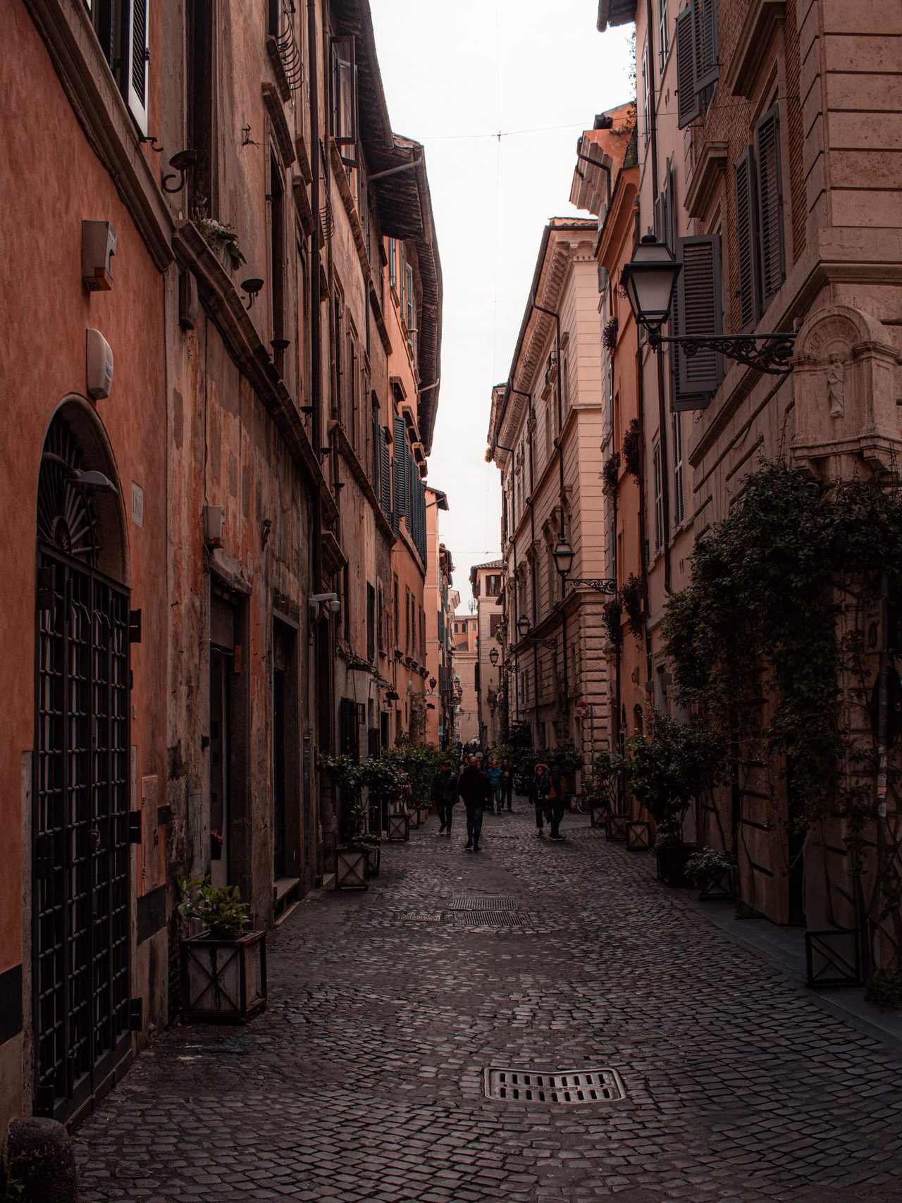 A warm, narrow cobbled street in Rome