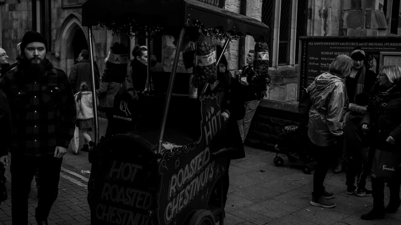 A street vendor roasting chestnuts on a cold day