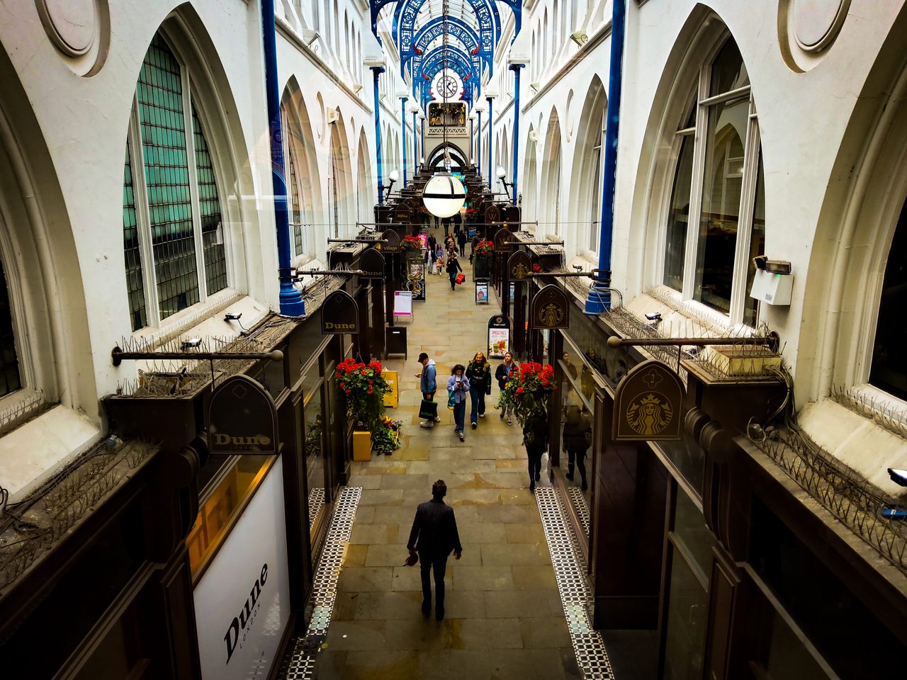 A Victorian shopping arcade in Leeds, light falling through its glass roof