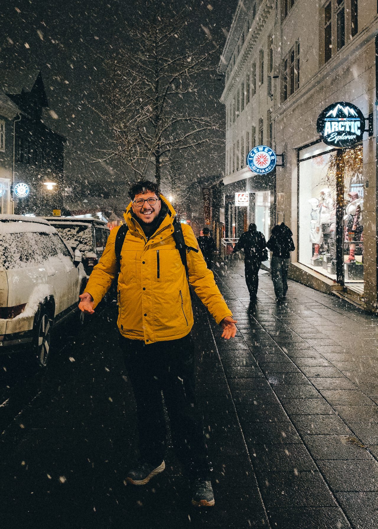 Snow falling on a Reykjavík street at night