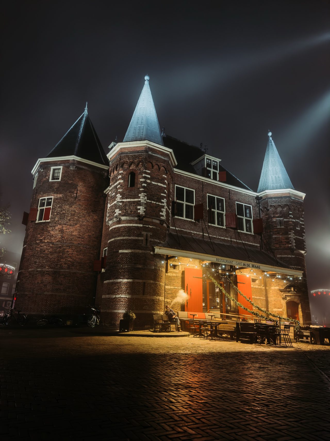 The medieval Waag illuminated at night on Nieuwmarkt